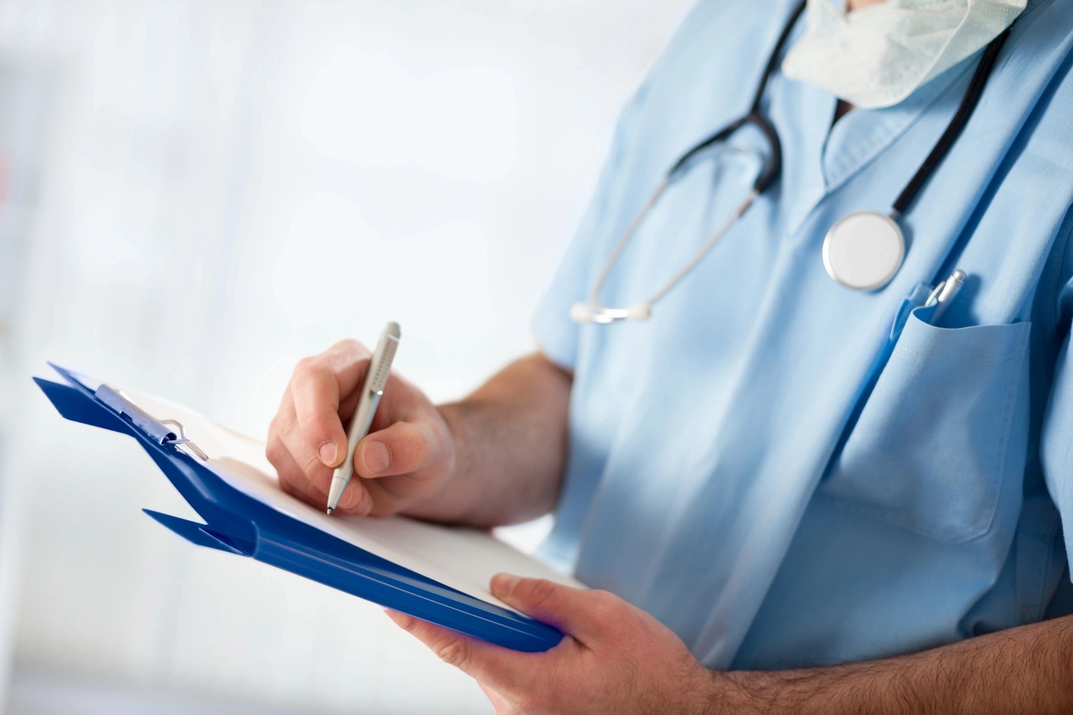 Healthcare professional with clipboard and stethoscope